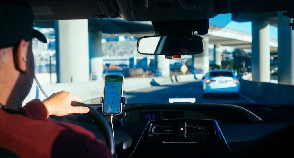 person holding iphone 6 inside car